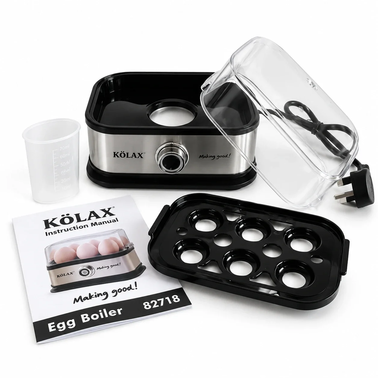 KöLAX egg boiler with its removable six-egg tray, clear lid, measuring cup and instruction manual displayed separately.