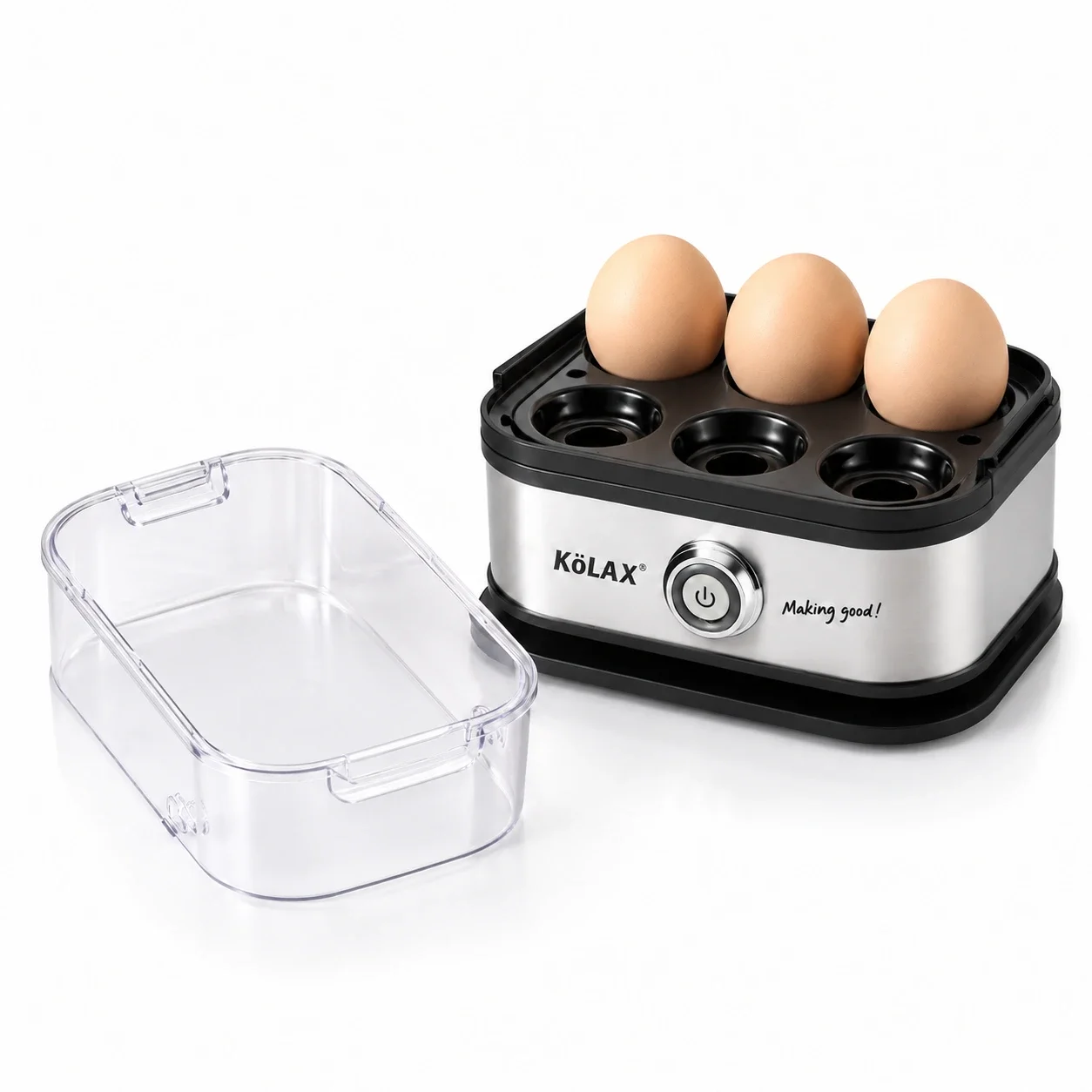 KöLAX egg boiler holding three eggs in its six-position tray, with the clear lid placed alongside.